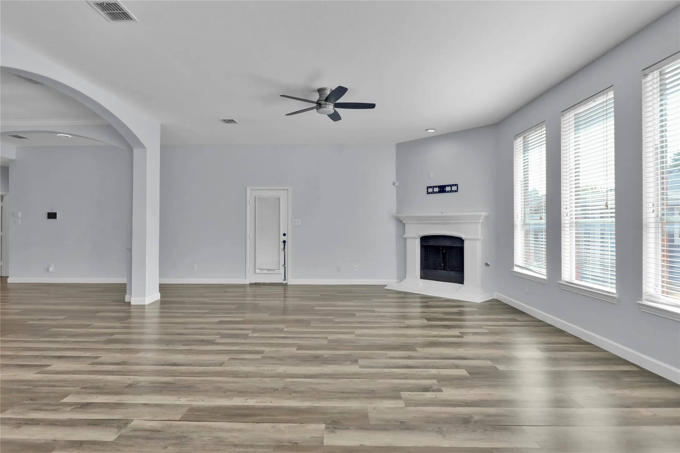 Living room with an abundance of windows and fireplace.