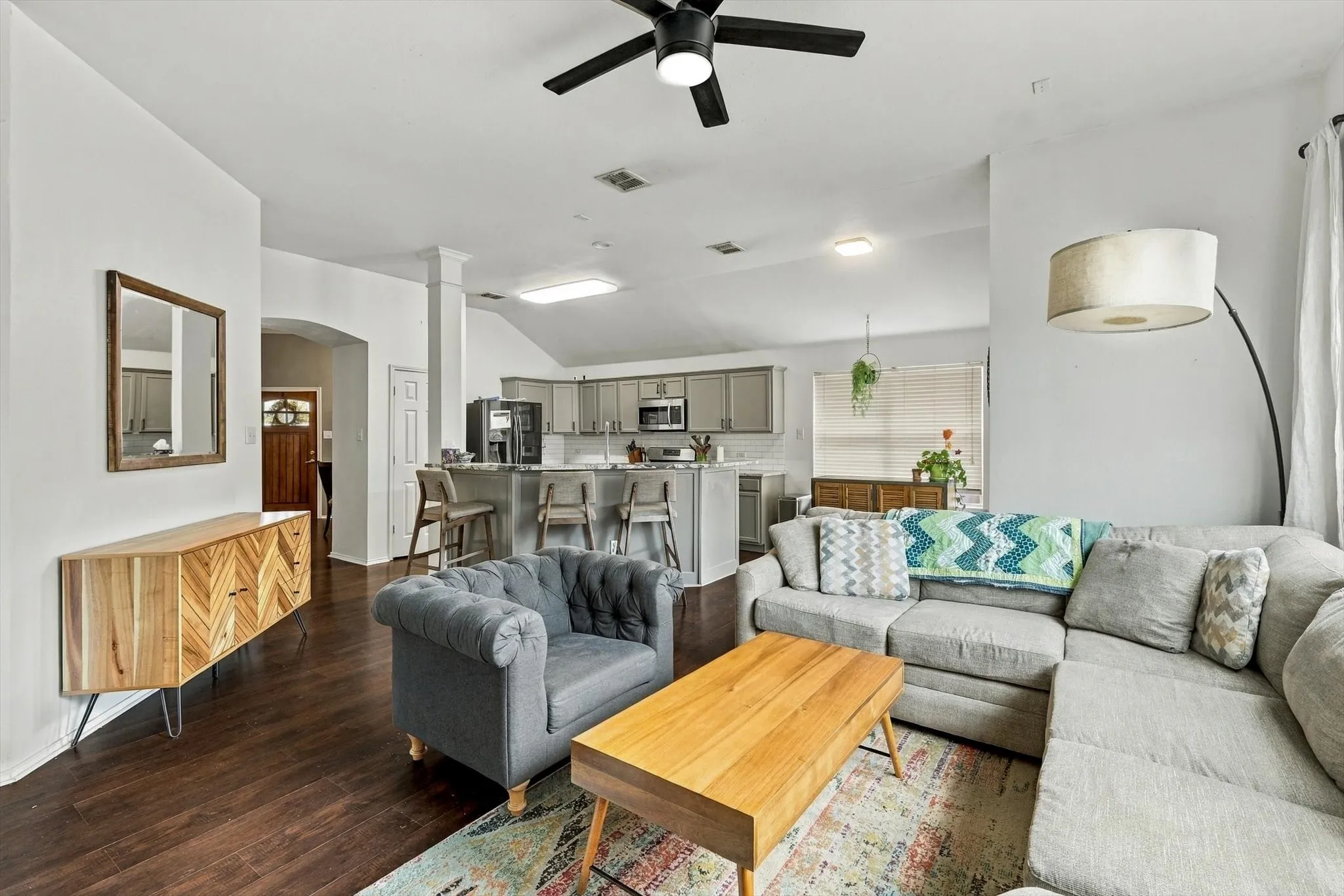 Wood-finish flooring, recessed lighting, and ceiling fan in the living area