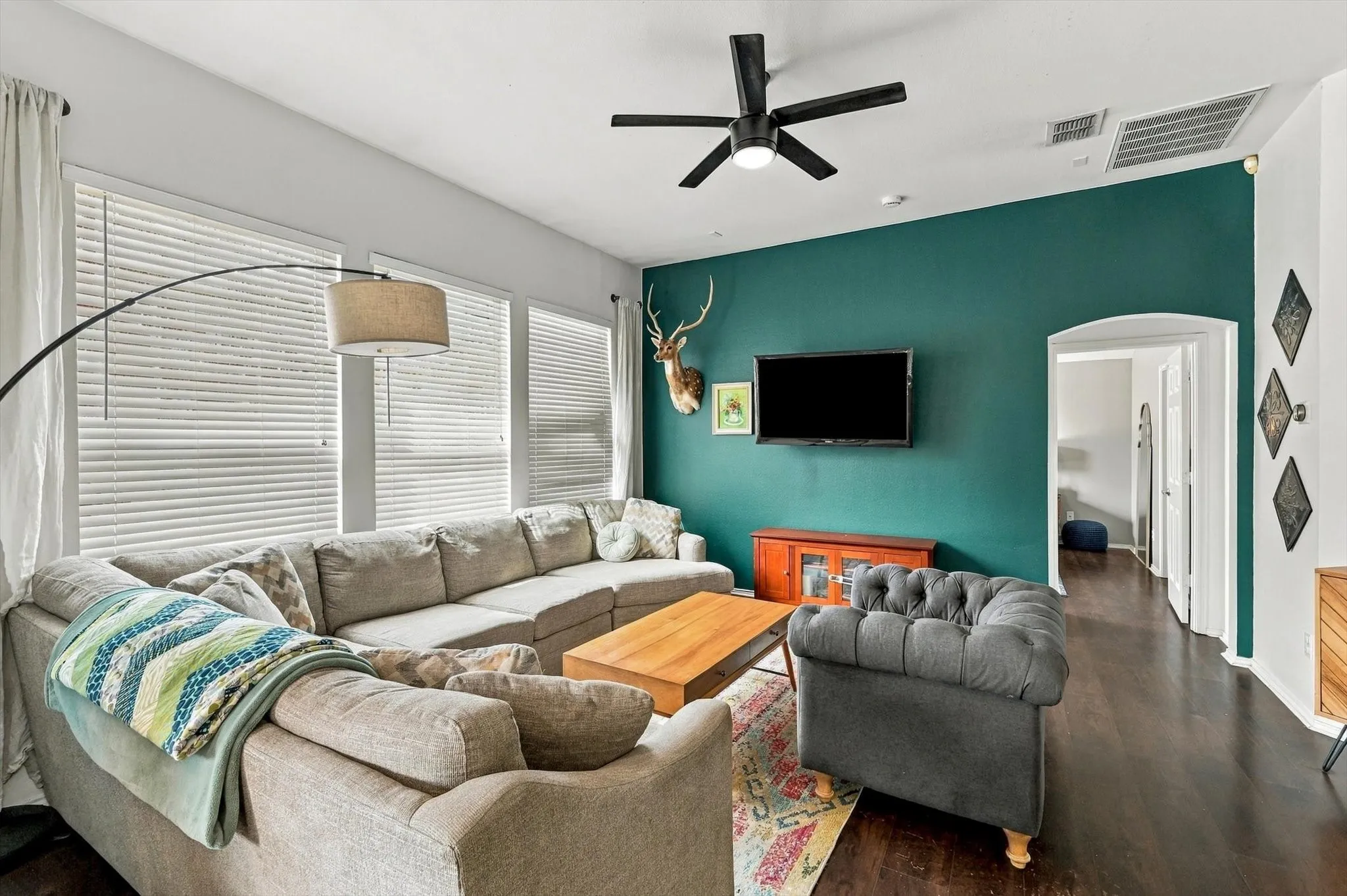 Dark wood-finish flooring with a contrasting accent wall