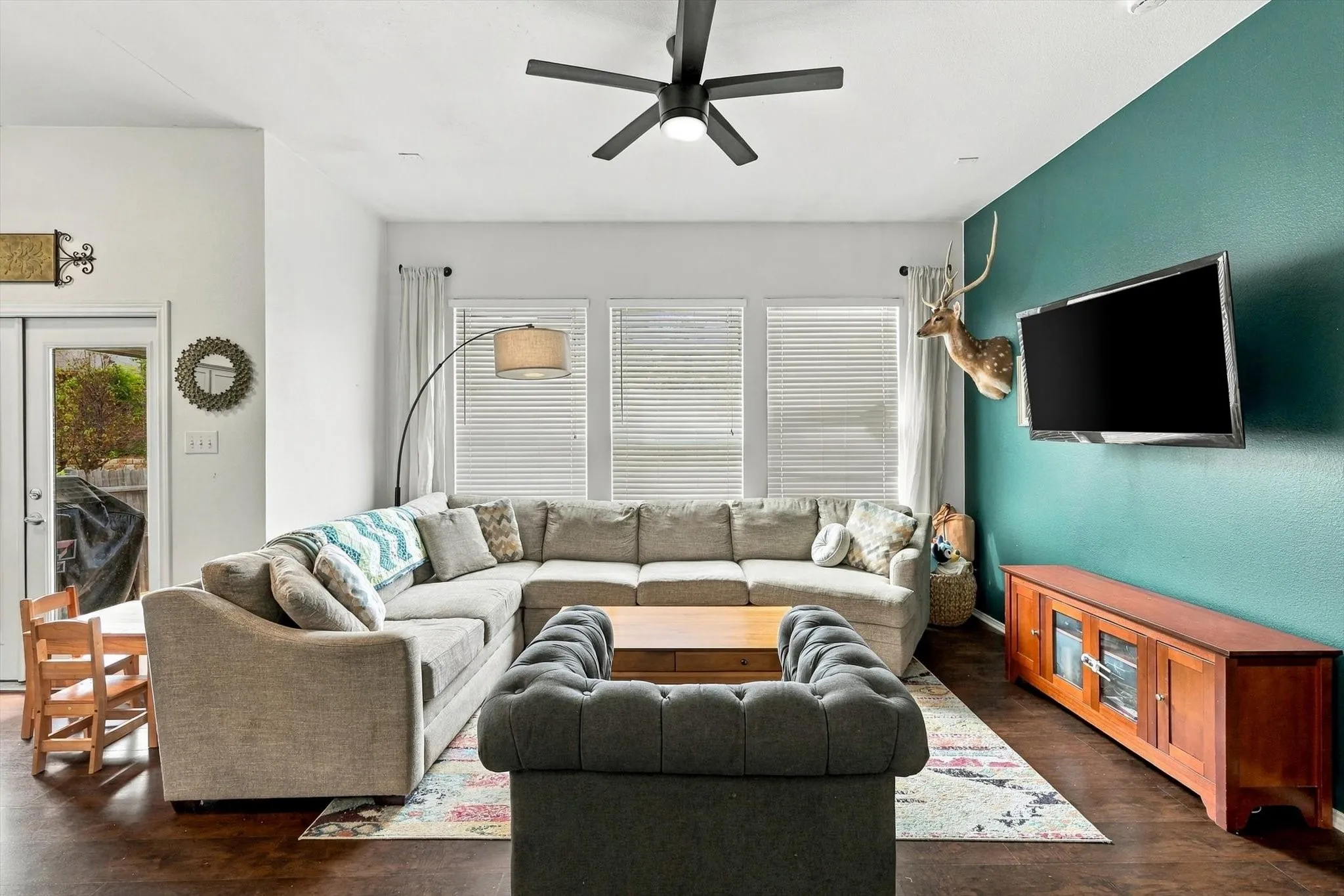 Wood-finish flooring throughout, with a ceiling fan and recessed lighting
