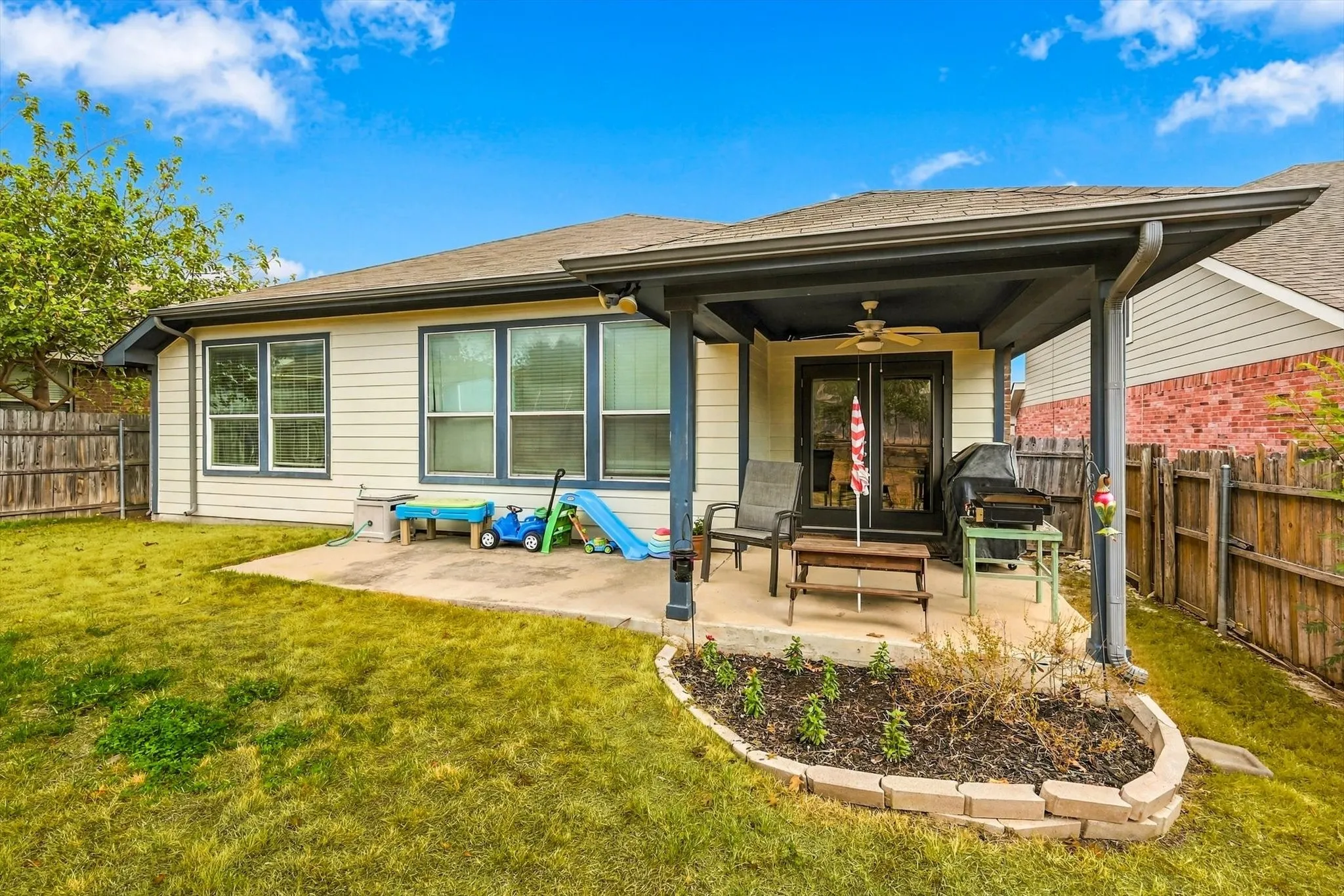 Covered patio featuring a ceiling fan and direct outdoor access