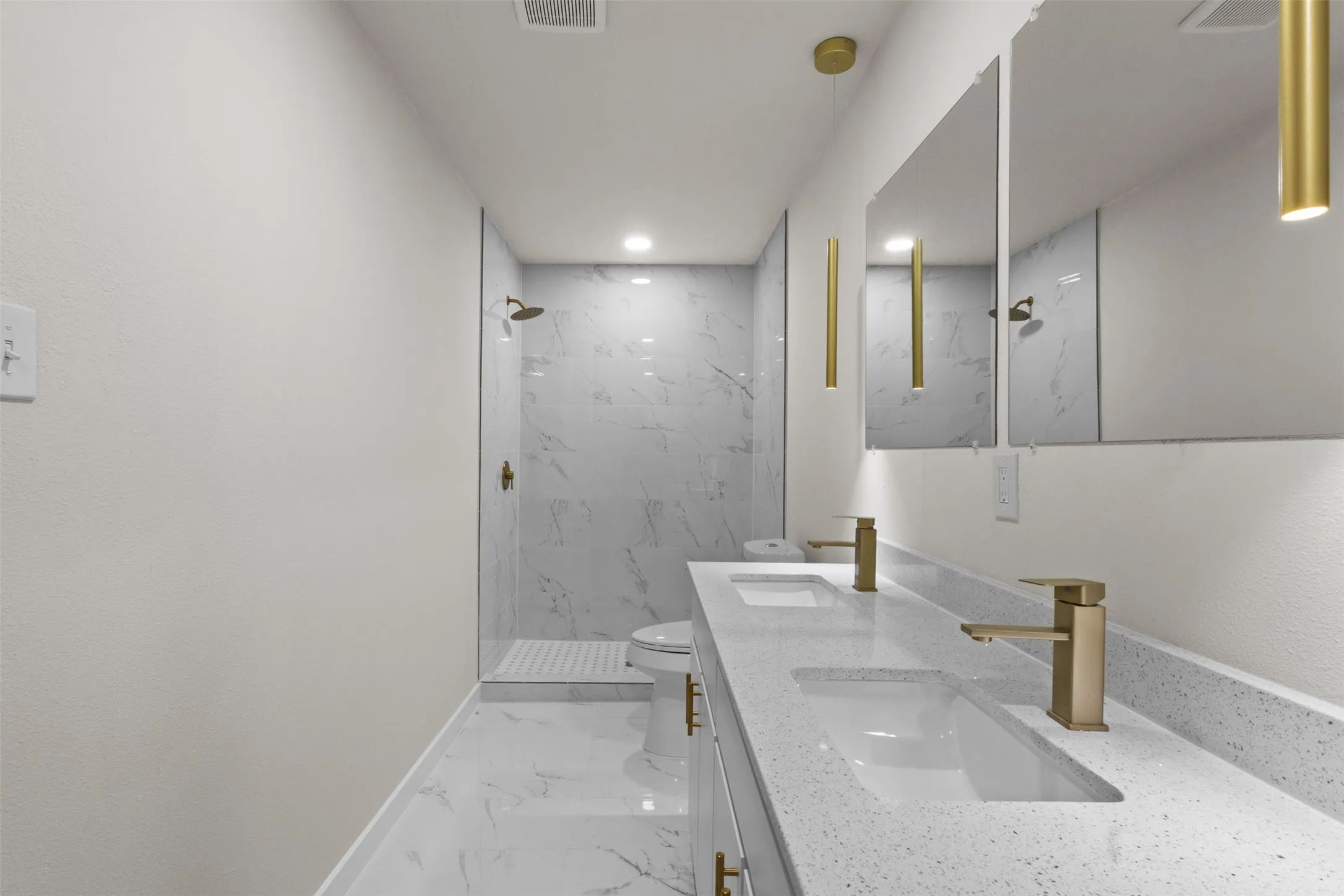 Dual vanity with integrated sinks and gold-finish faucets