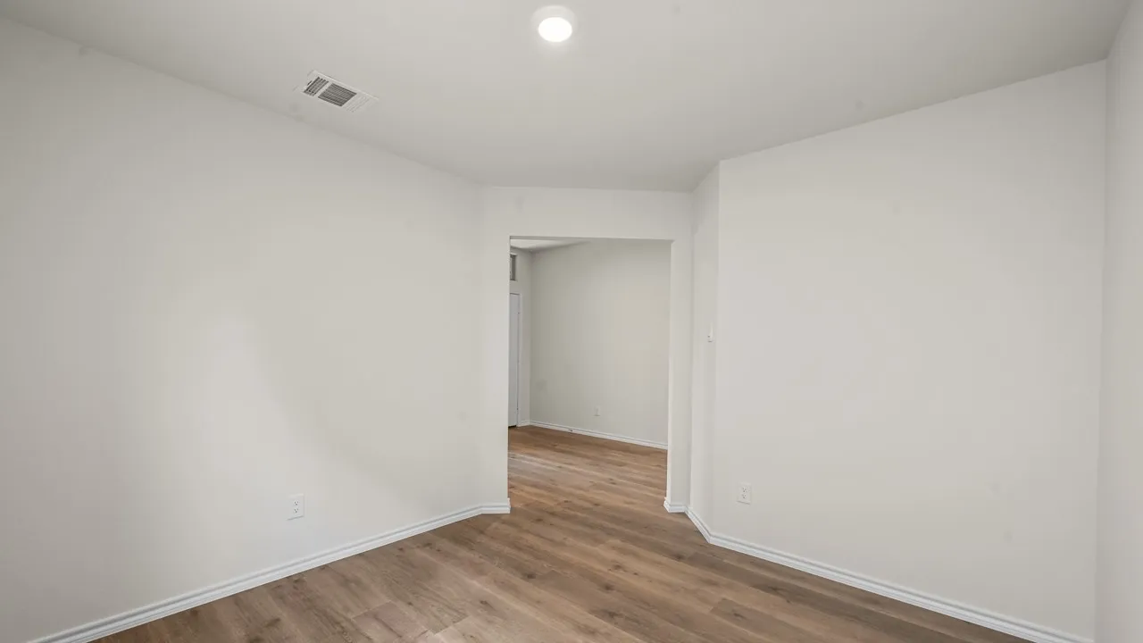 Recessed lighting, wood-finish flooring, and white painted walls