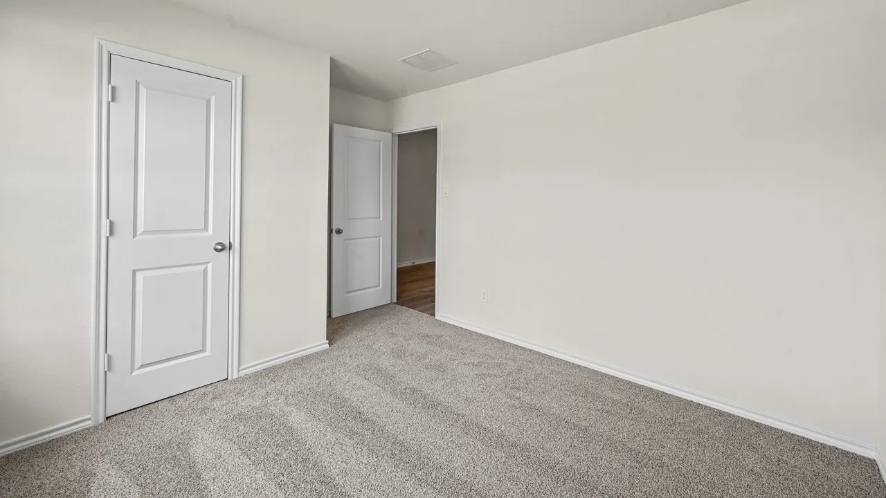 Neutral wall color with plush carpet flooring