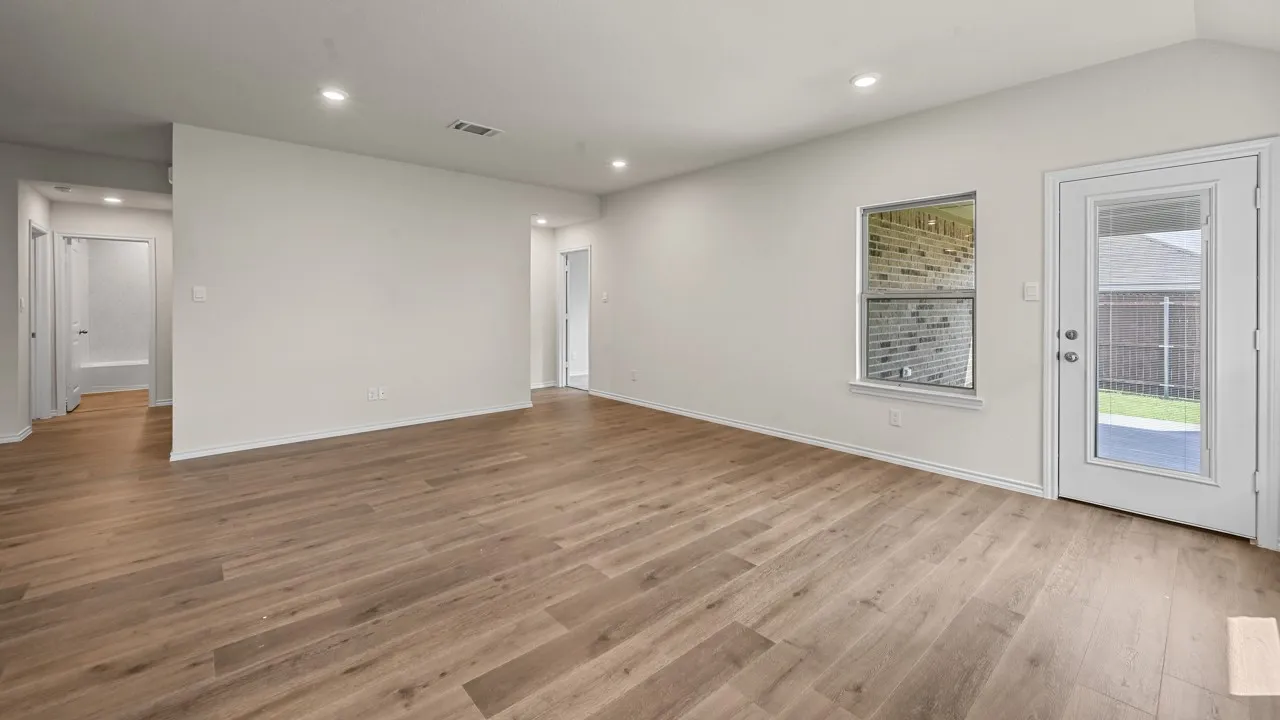 Bright interior space featuring wood-finish flooring, recessed lighting, and a glass-paneled exterior door