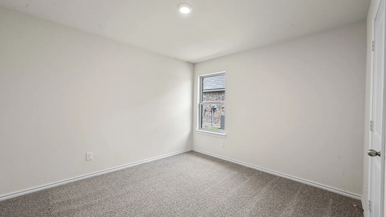 Recessed ceiling lighting, neutral-toned walls, and soft carpeting
