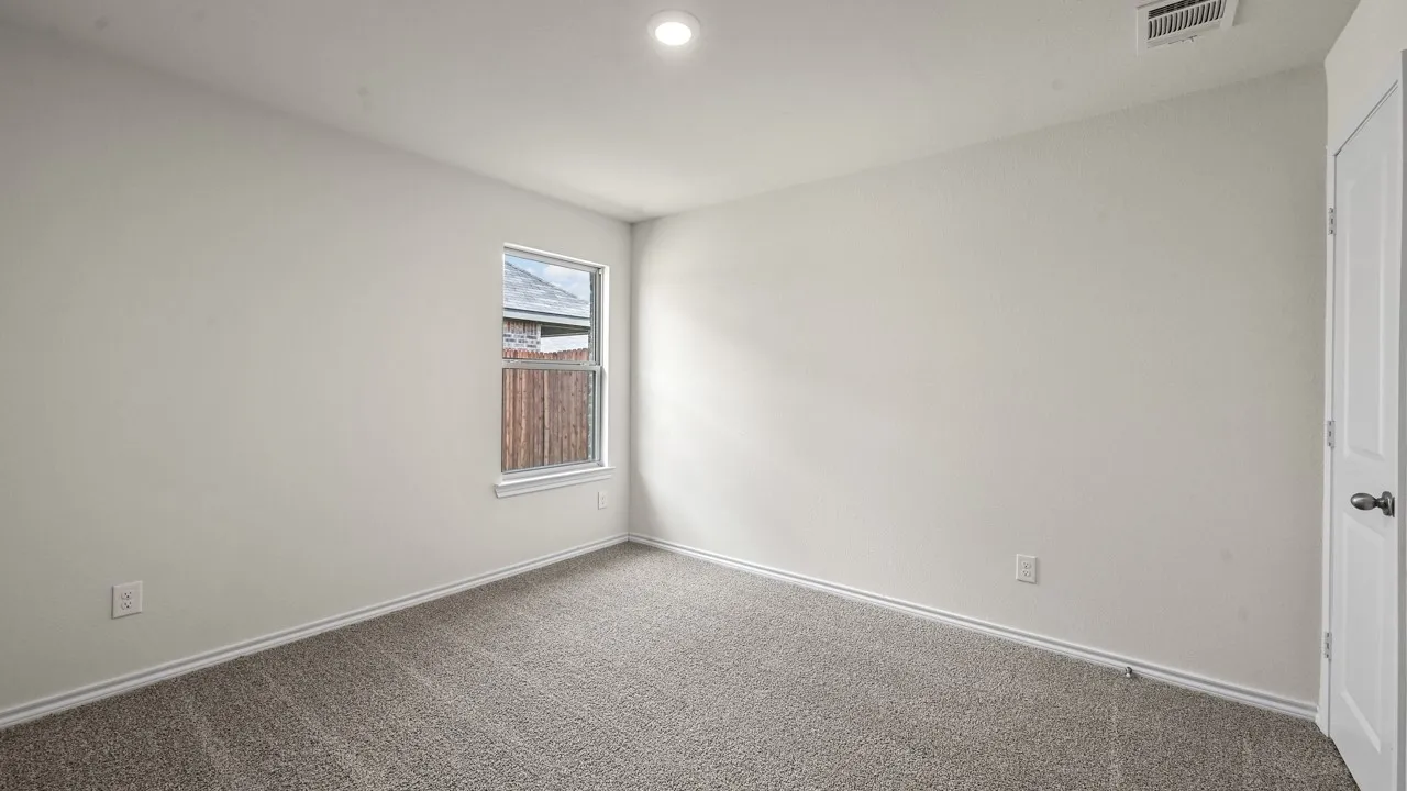 Neutral wall finishes, recessed lighting, window with white trim, gray carpeting, and a white interior door