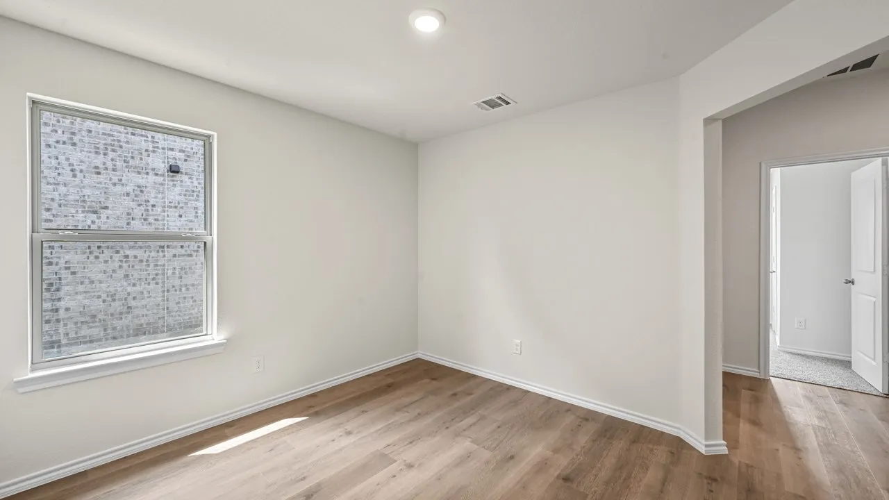 Recessed lighting, light wood-finish flooring, white walls, and a double-hung window