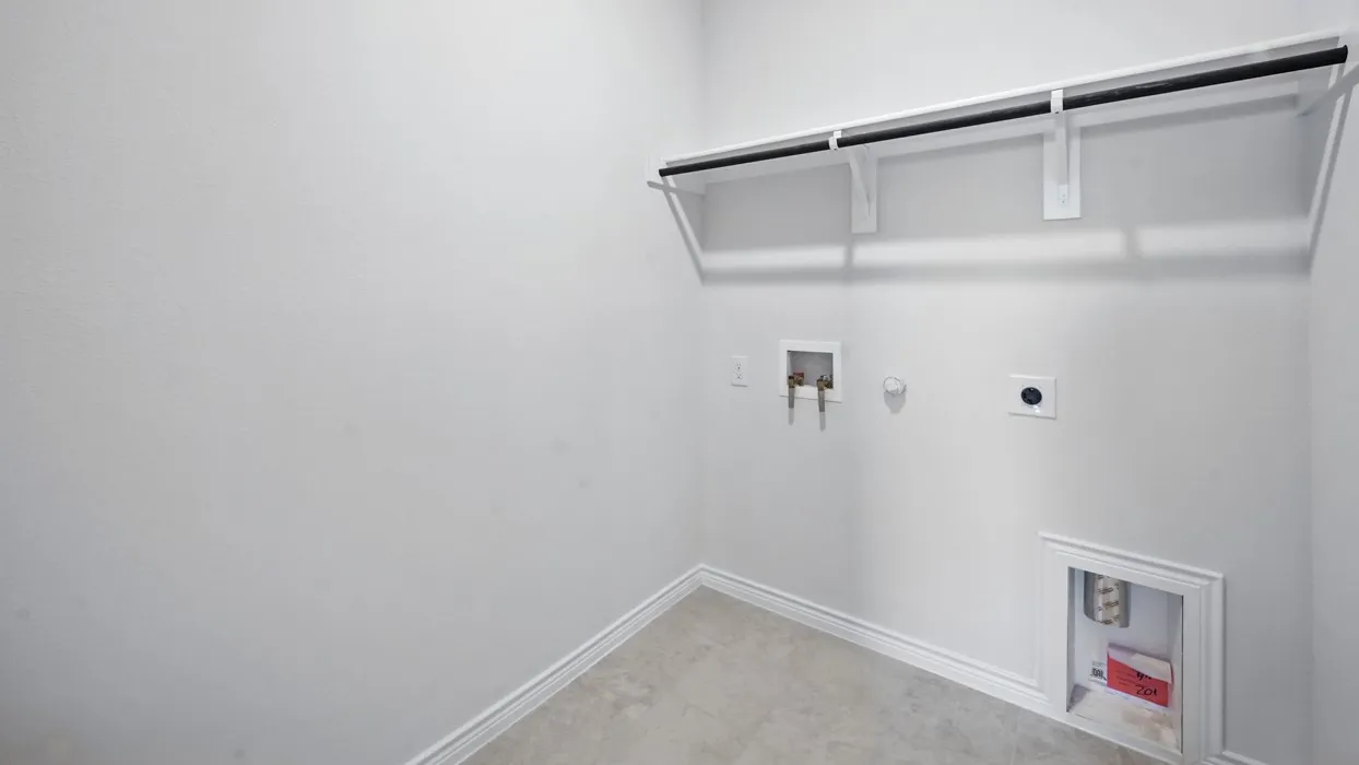 Laundry area with a built-in hanging rod, utility hookups, and tiled flooring