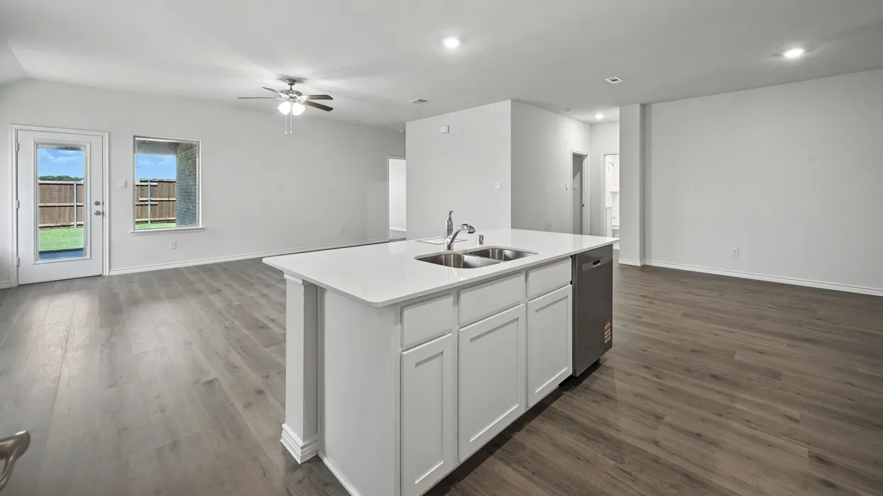 Expansive open-concept living area featuring wood-finish flooring, recessed lighting, and a ceiling fan