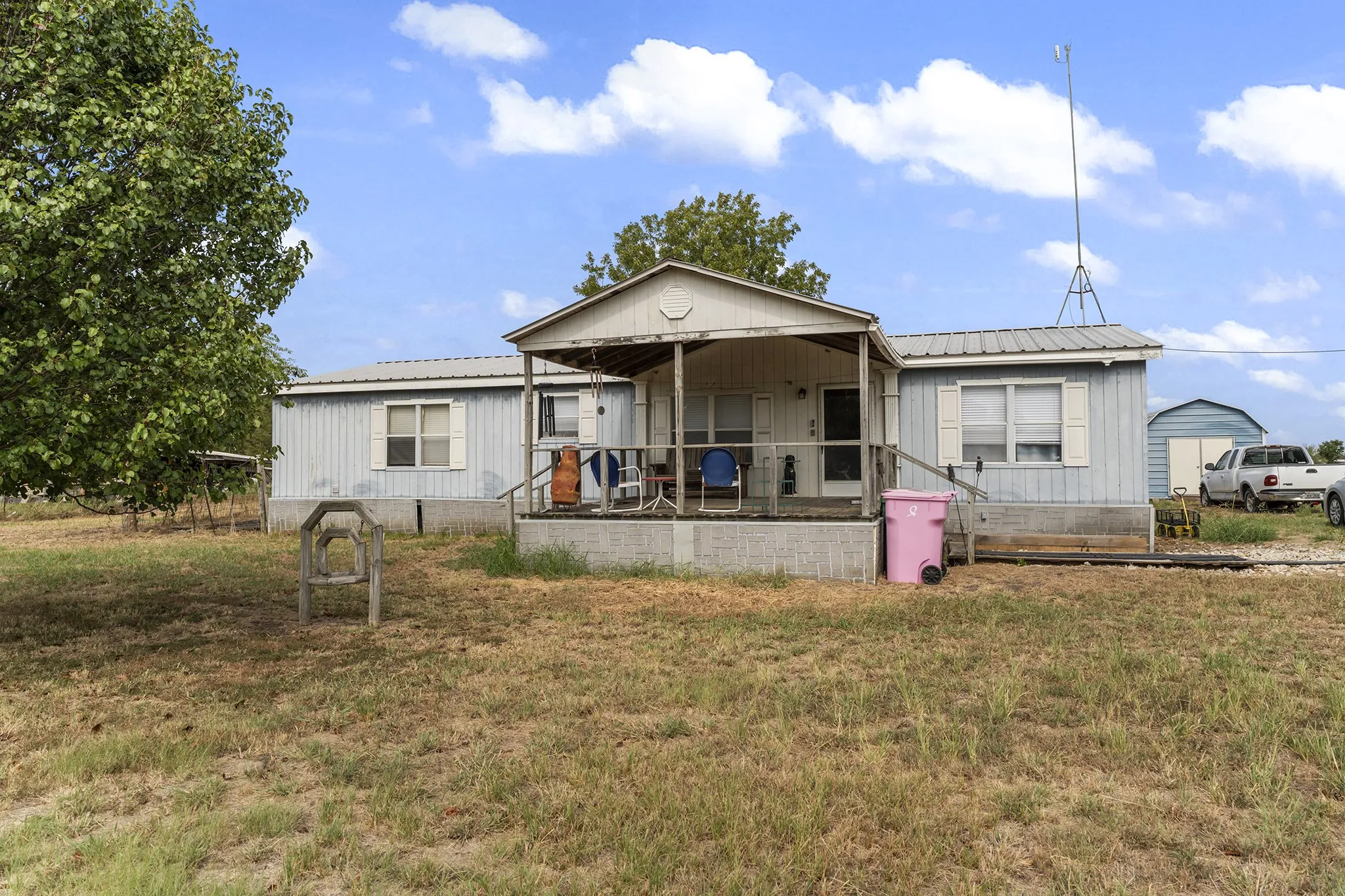 Single-story residence featuring a covered front porch and a metal roof