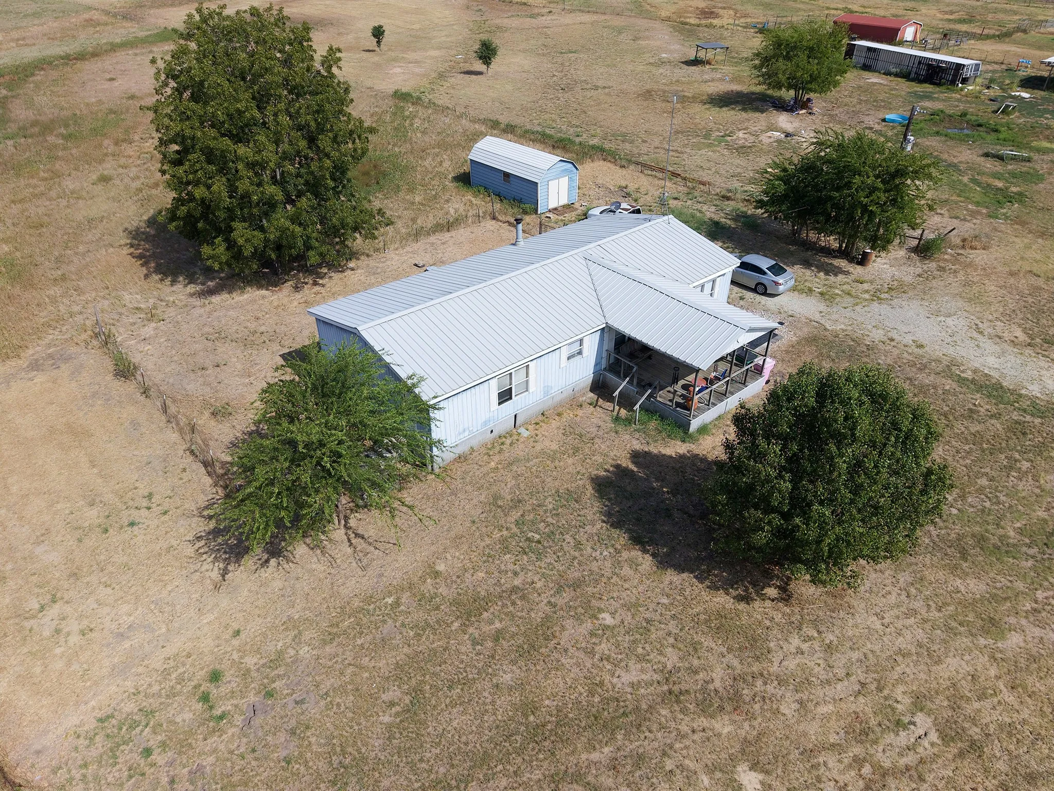 Single-story residence with a metal roof and an enclosed porch