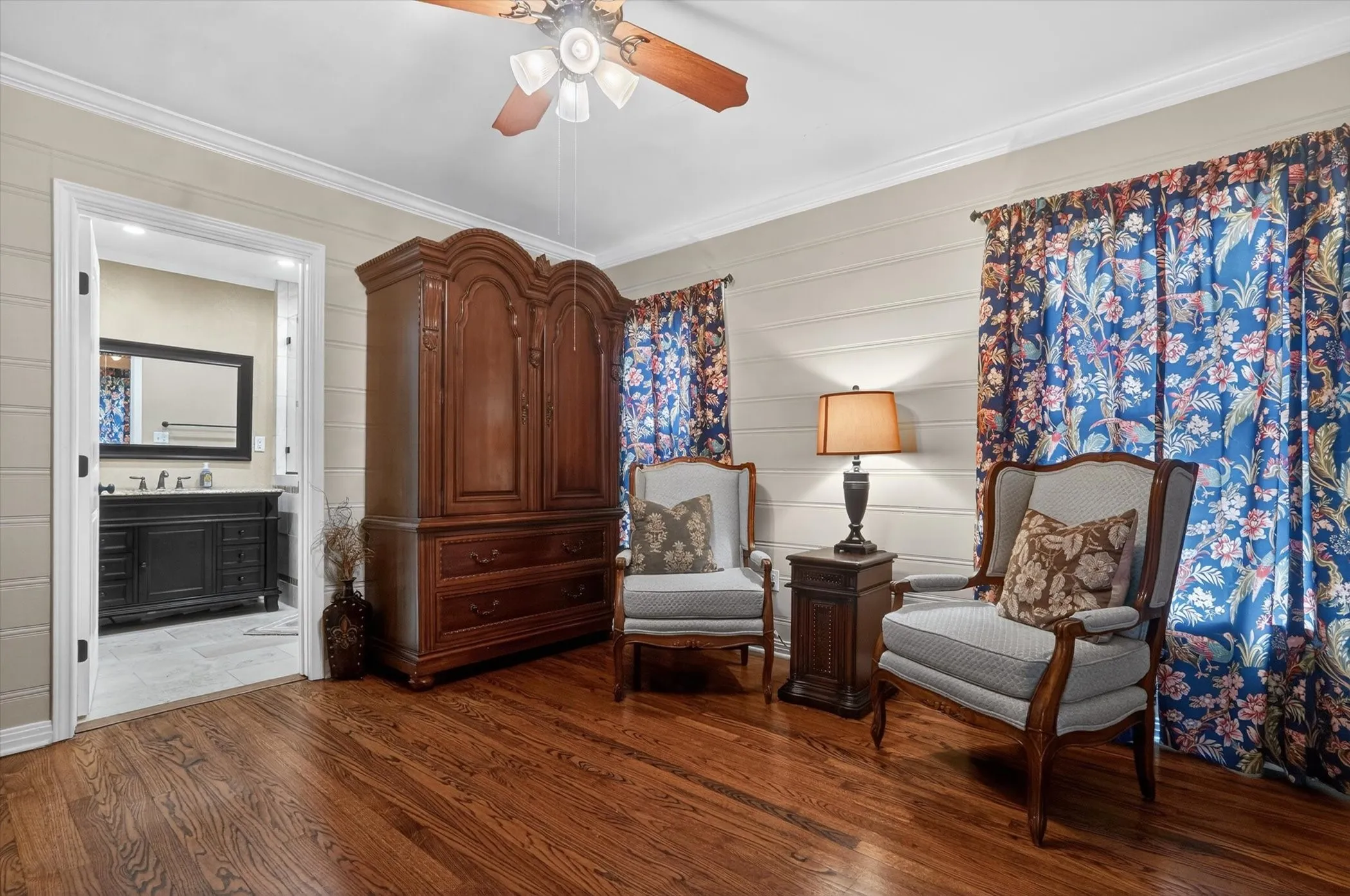 Rich wood-finish flooring with plank walls and crown molding