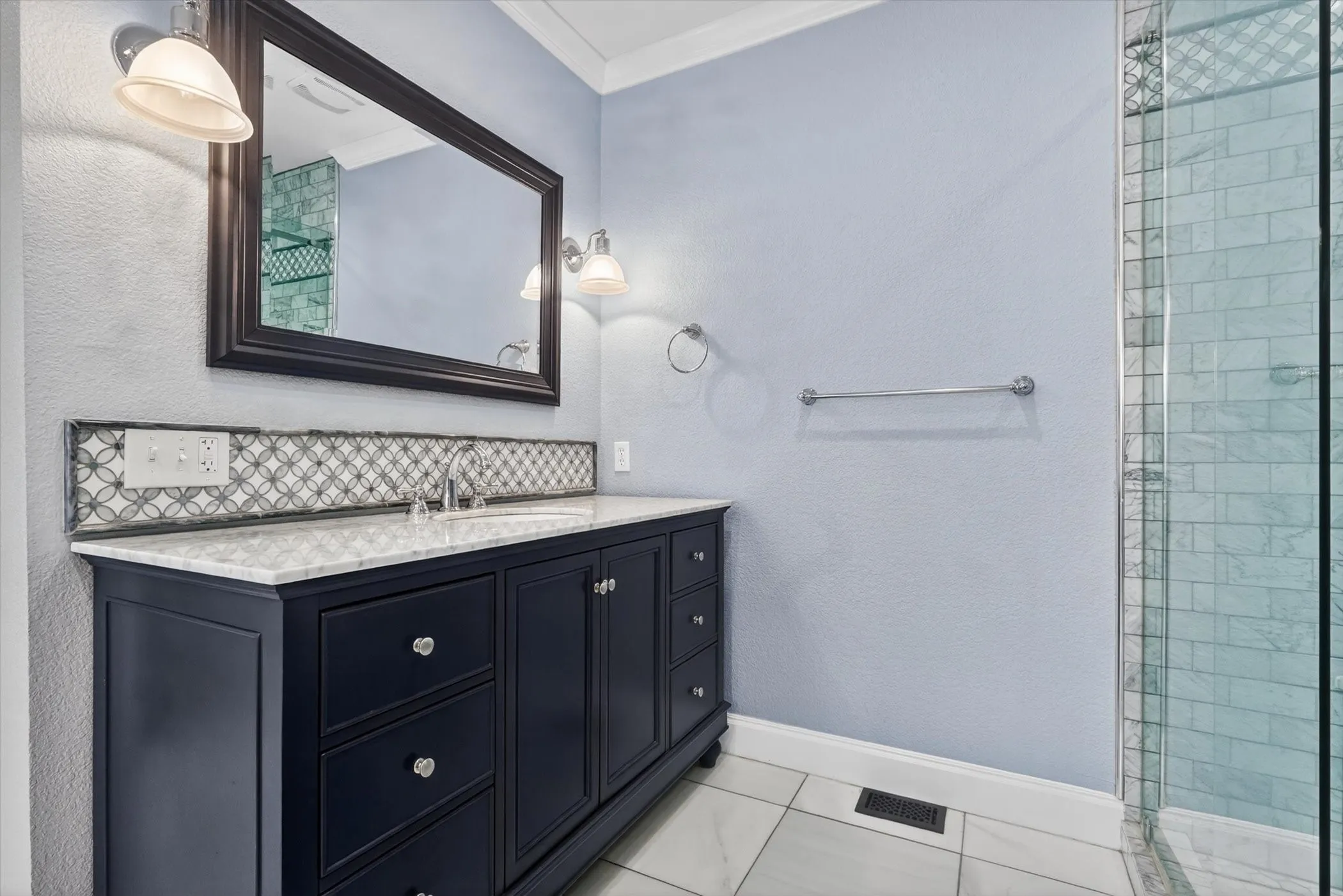 Bathroom vanity featuring a dark wood finish, a white countertop, and a decorative tile backsplash