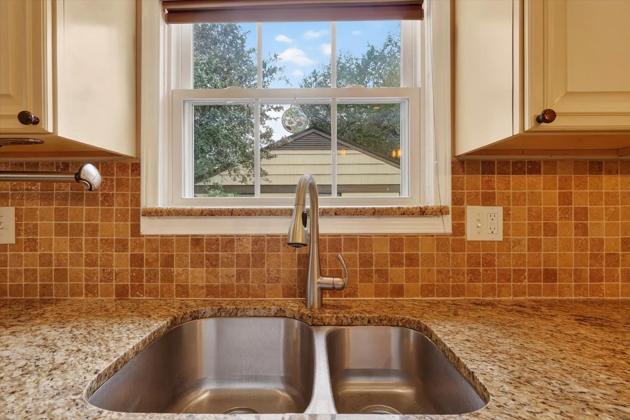 Dual-basin stainless steel sink with a gooseneck faucet