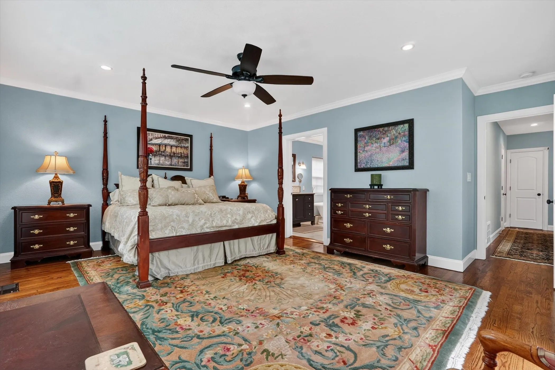Spacious room featuring hardwood flooring, recessed lighting, and a ceiling fan