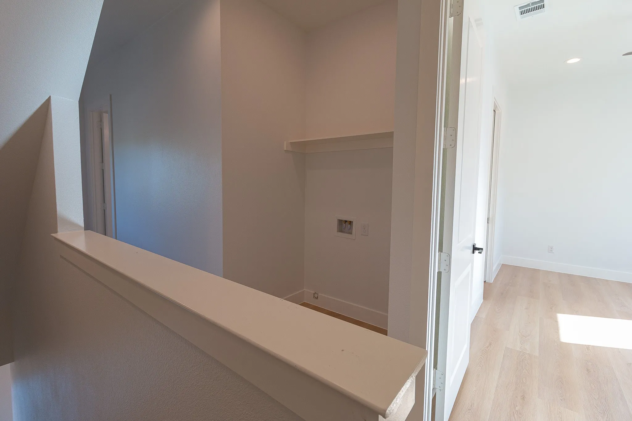 Hall with light hardwood / wood-style flooring