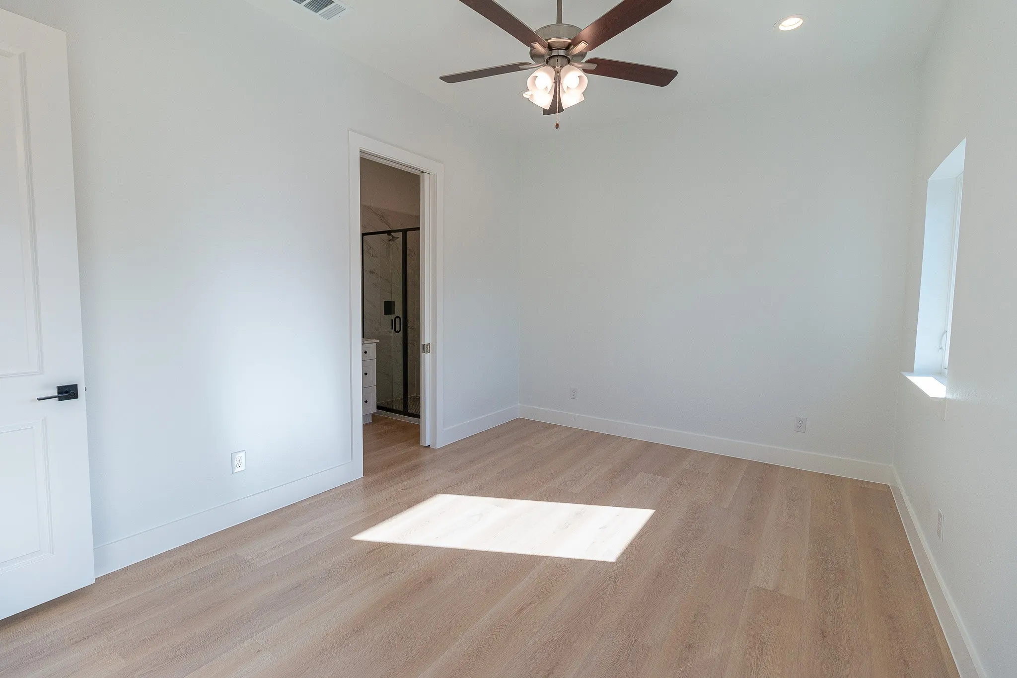 Unfurnished room with ceiling fan and light wood-type flooring