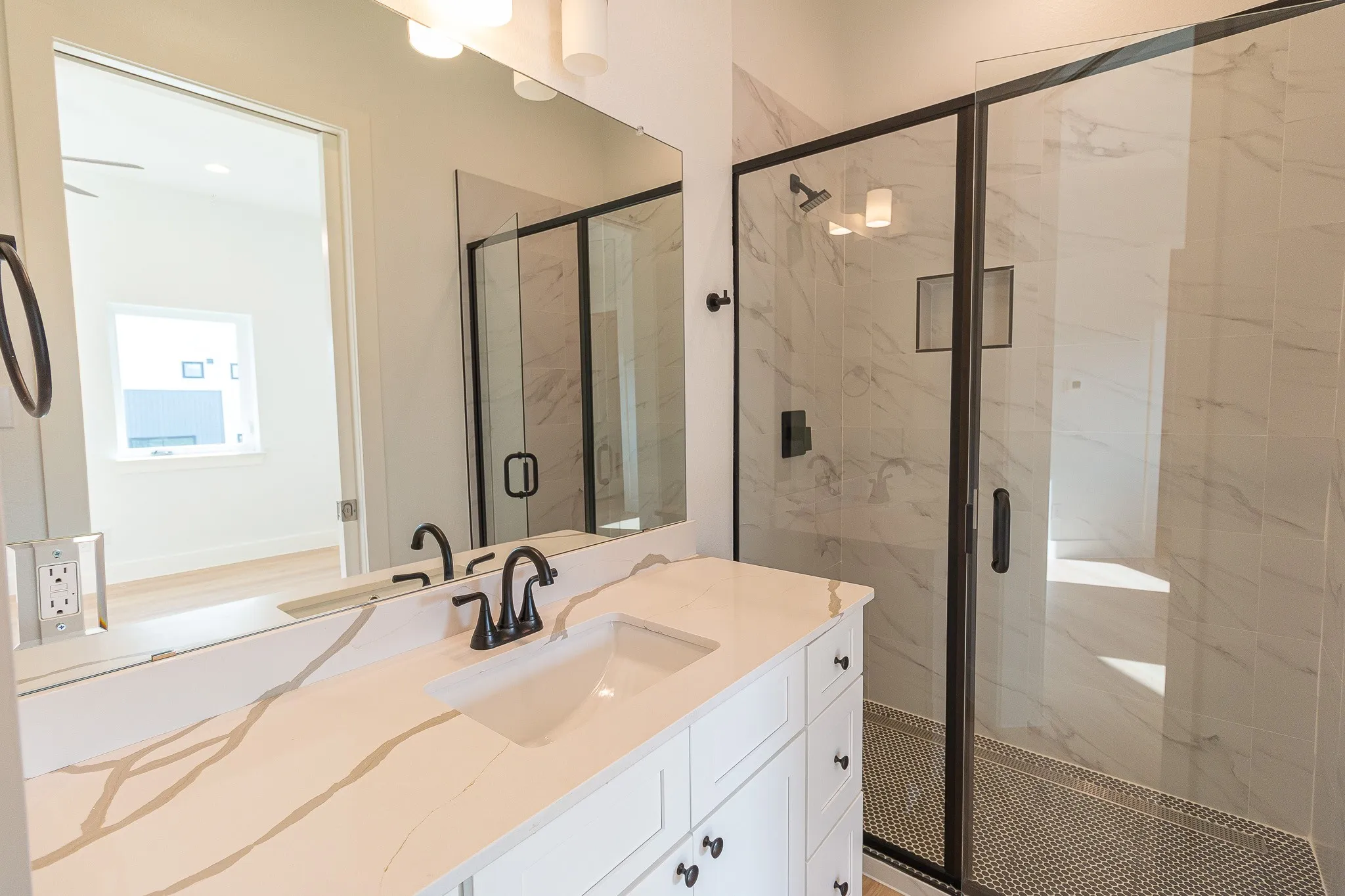 Bathroom featuring vanity and an enclosed shower