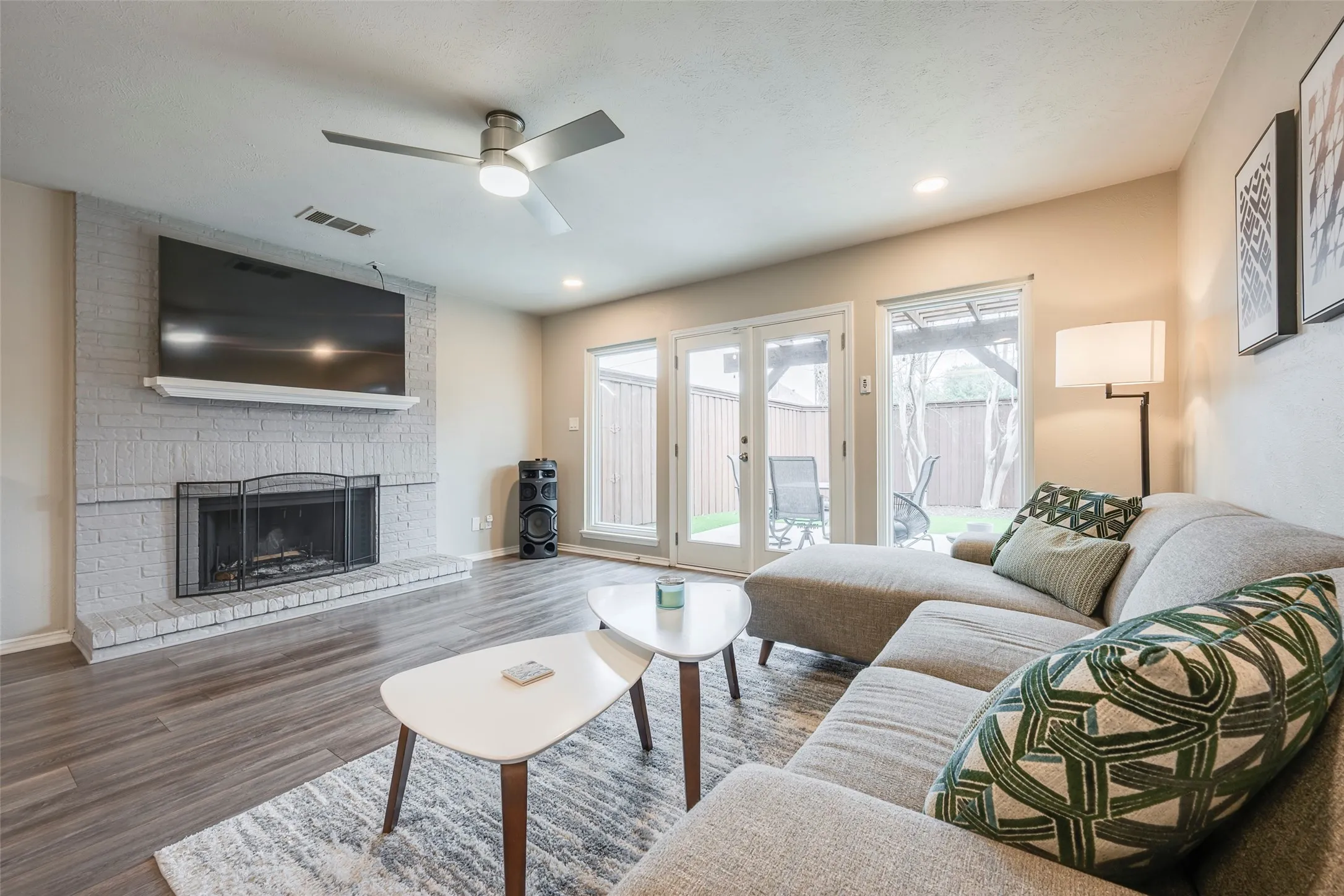 2nd living room also has fireplace and looks over the private backyard patio