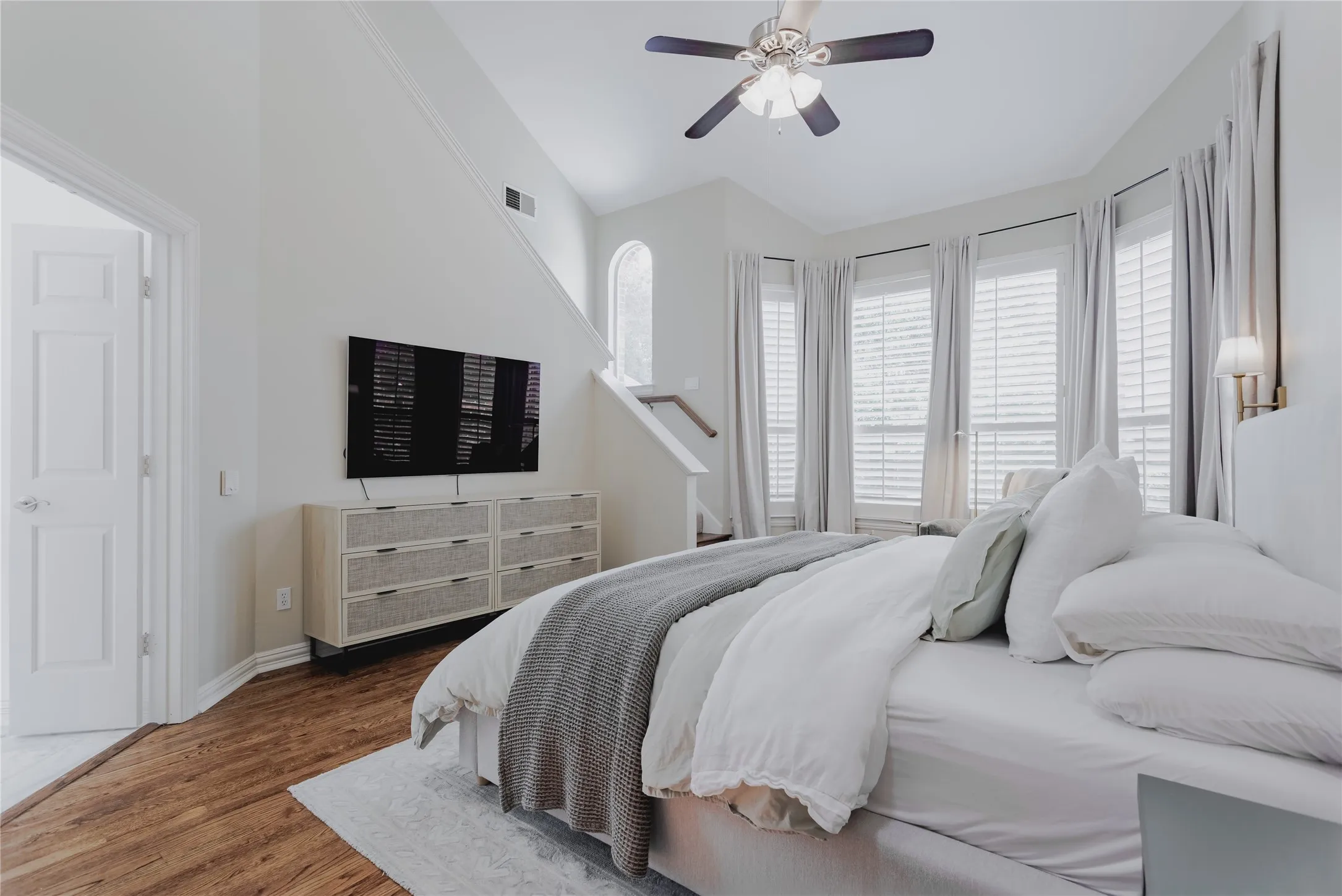 Lovely Primary Bedroom with Bay Window for seating and Stairs leading to the Loft aka YOUR Convenient Office Space!