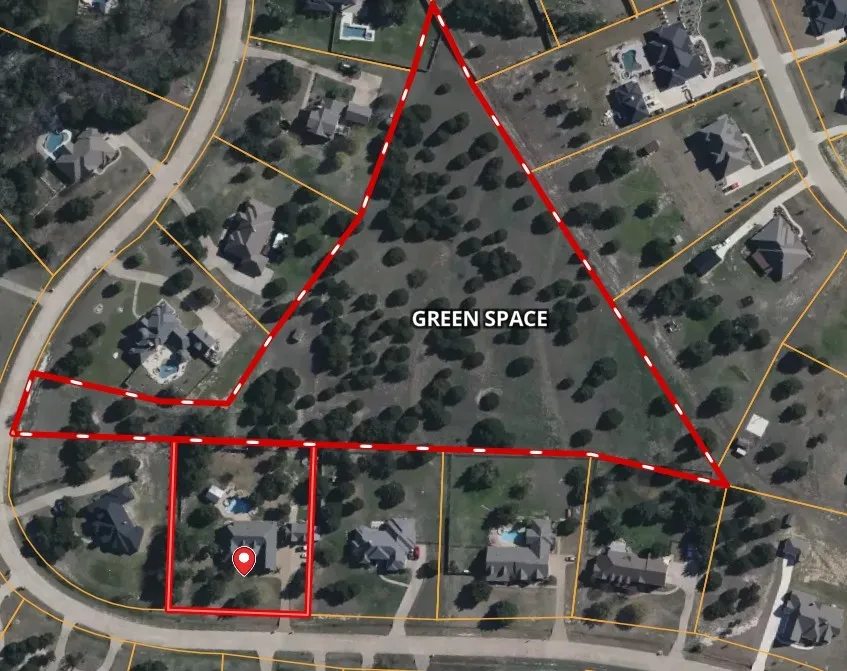 Aerial of property and HOA green space accessible behind the home.