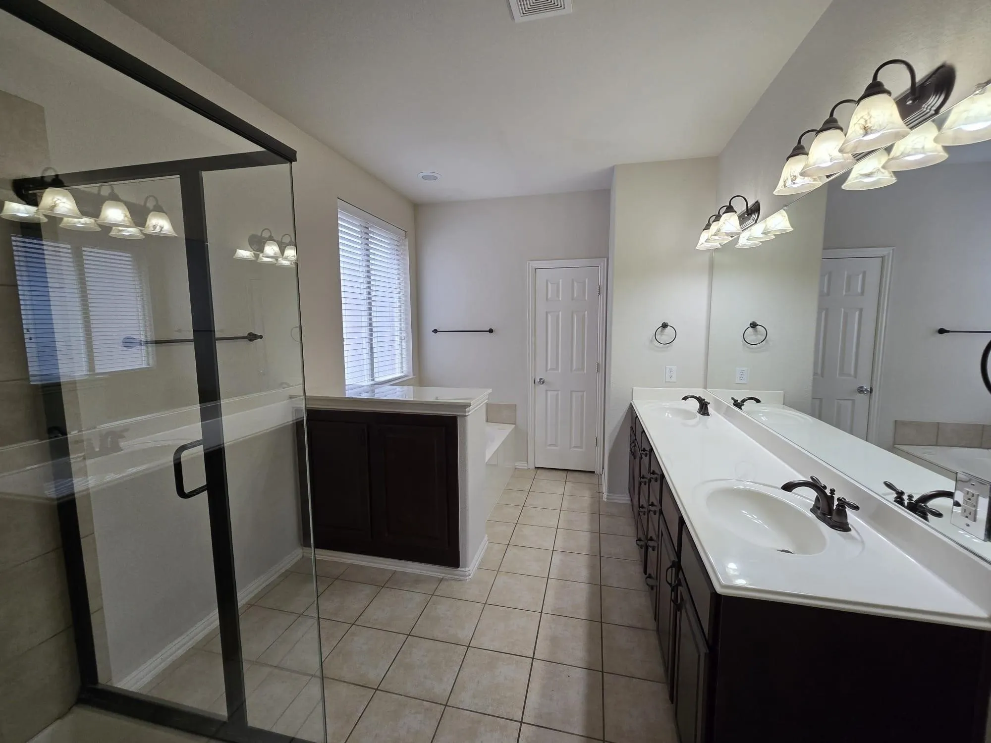 Bathroom featuring vanity, tile patterned floors, and separate shower and tub