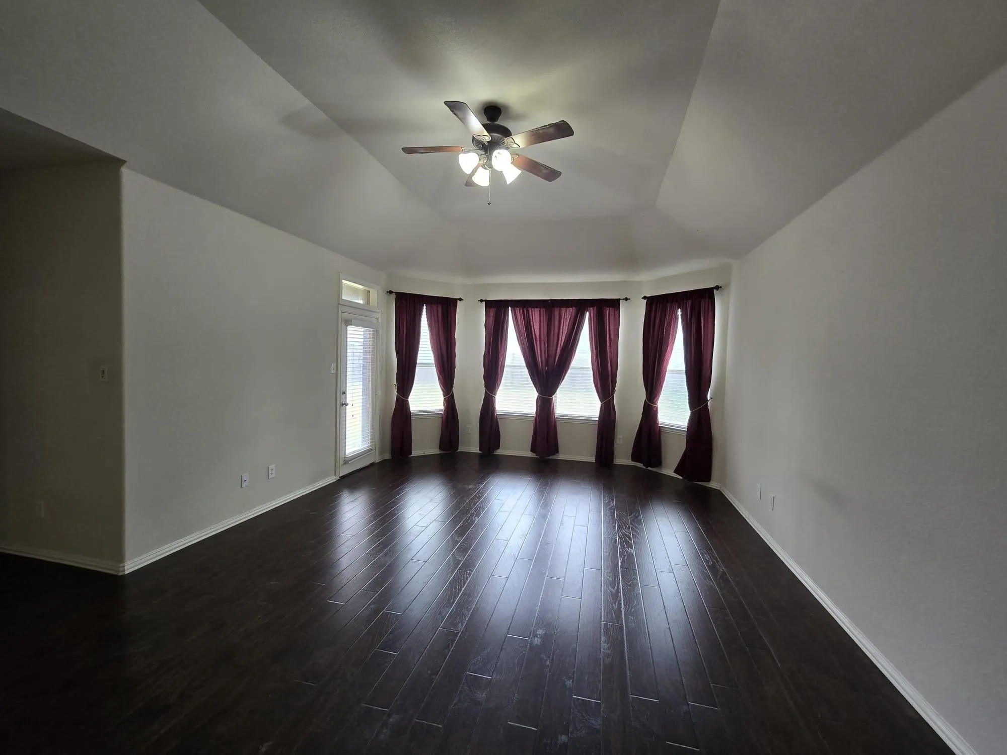Master room with ceiling fan, lofted ceiling, and dark hardwood / wood-style flooring