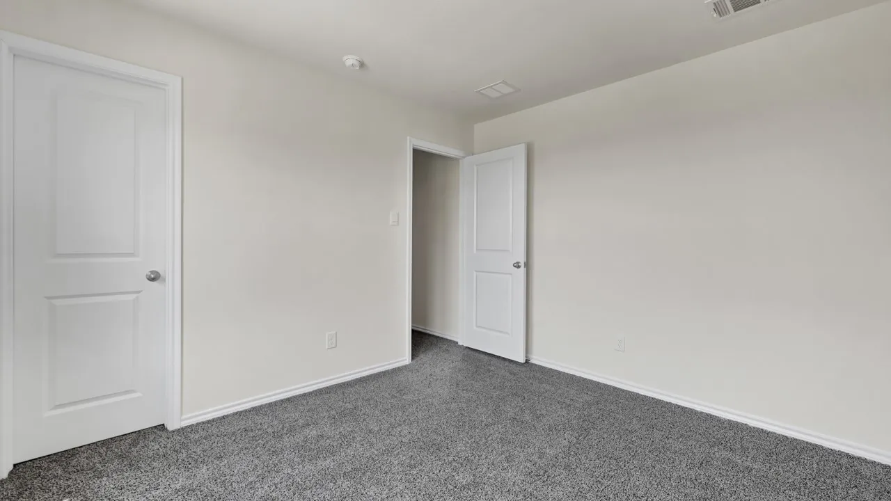 Plush gray carpeting with light-toned walls and white trim