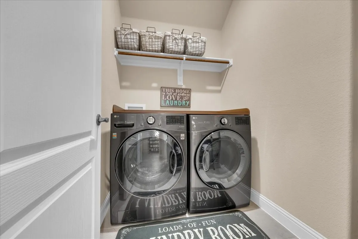 Built-in laundry appliances with a wood-finish countertop