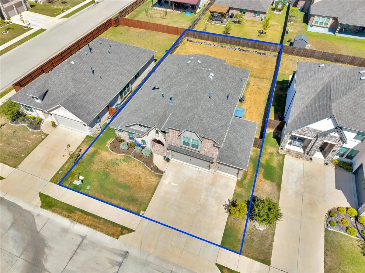 Two-story residence with a gray shingle roof, attached garage, concrete driveway, and front landscaping