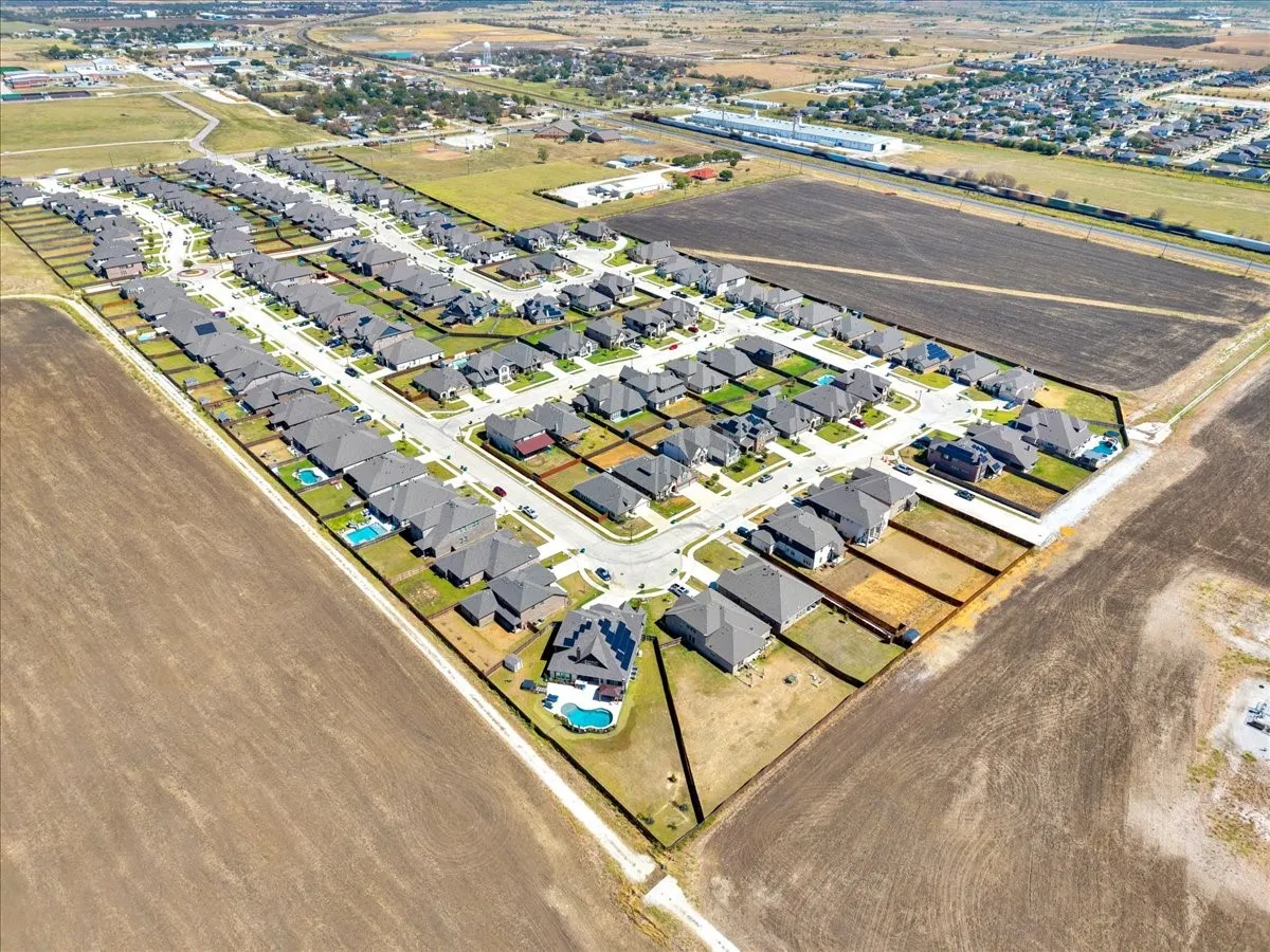 Residential development featuring uniform lot sizes, paved street network, and a mix of homes with and without private swimming pools