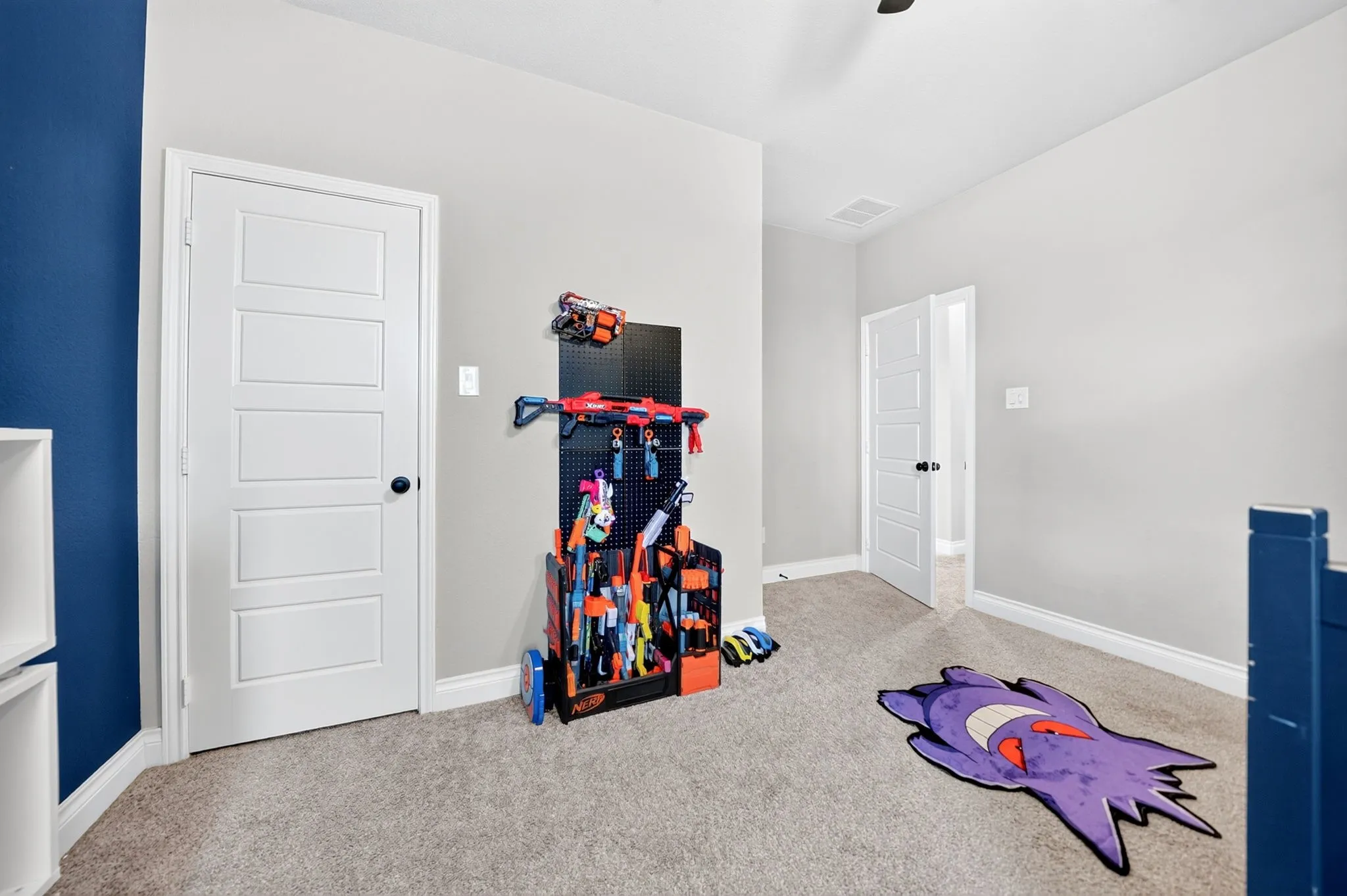Carpeted flooring, white trim, and white five-panel interior doors