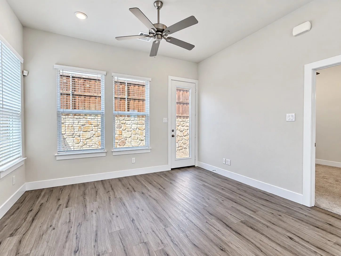 Wood-finish flooring, recessed lighting, and a ceiling fan with light fixture