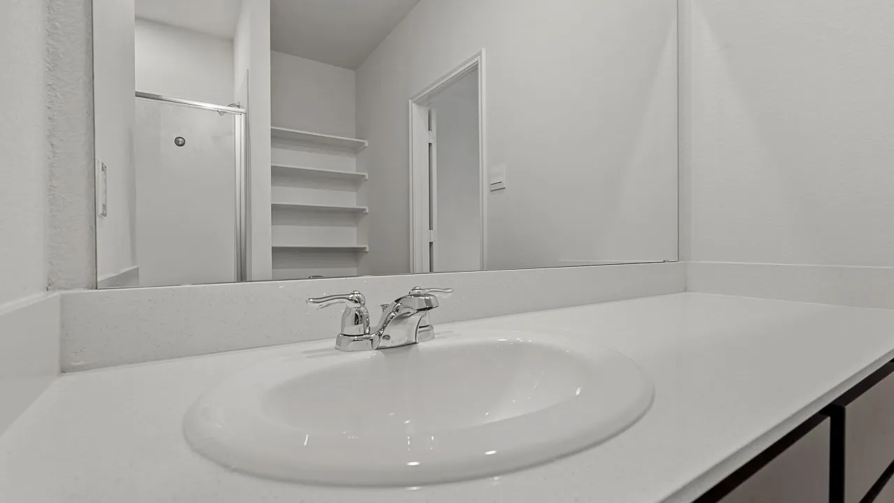 Vanity with integrated sink, chrome faucet, and expansive counter space