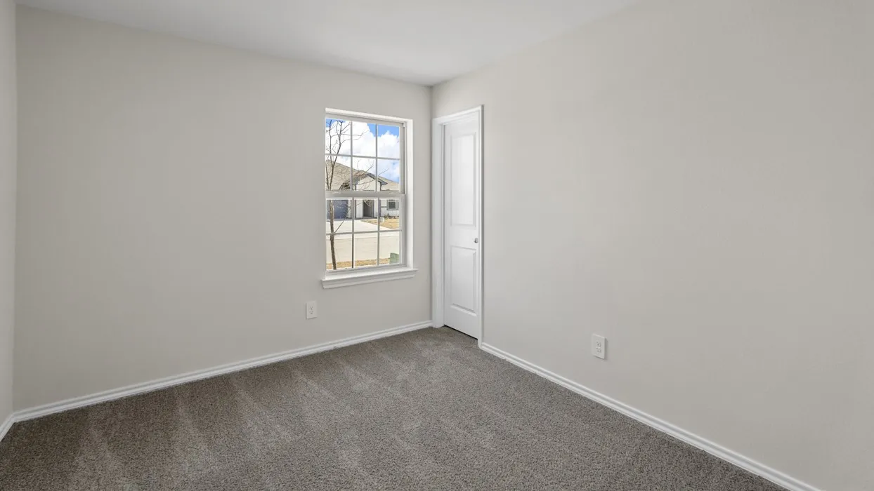 Neutral tone wall finishes, gray carpeting, white trim, and a paneled interior door