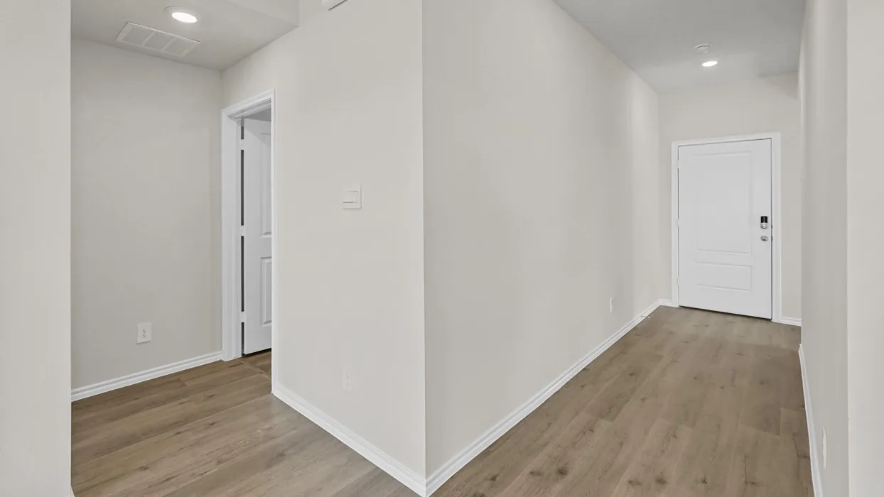 Wood-finish flooring, recessed lighting, and white trim