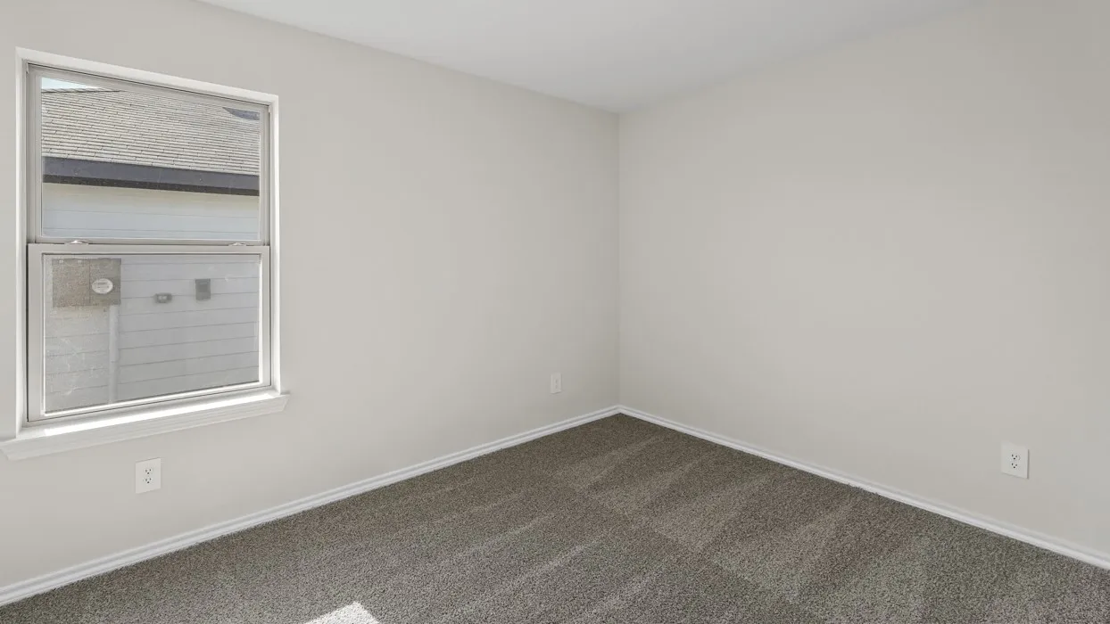 Carpeted flooring, white trim, and a window with white casing