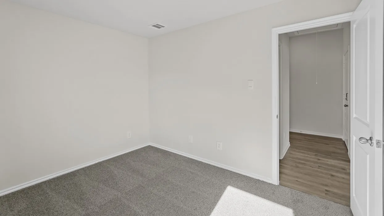 Light gray carpeting with white baseboards