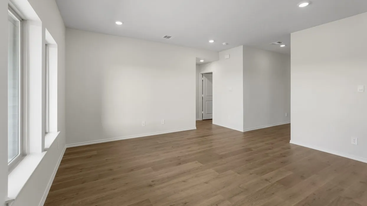 Recessed lighting, wood-finish flooring, white walls, and multiple windows