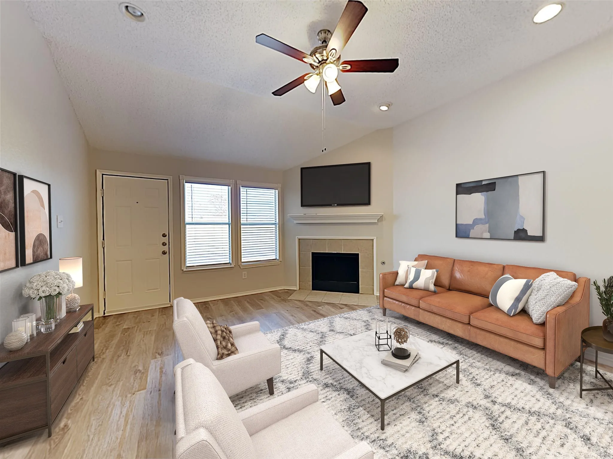 Vaulted ceiling with a ceiling fan, recessed lighting, wood-finish flooring, and a corner fireplace with a mantel