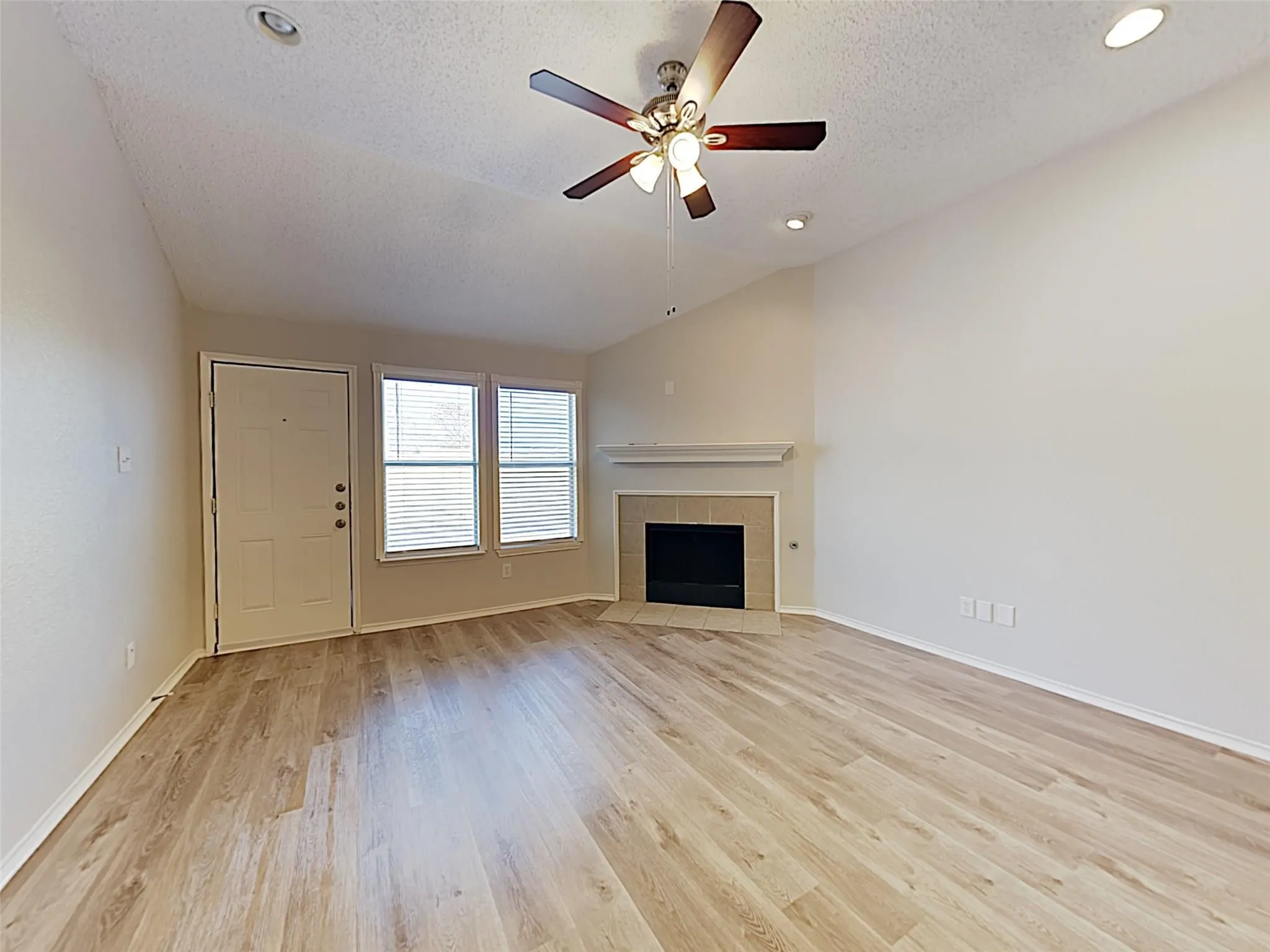 Wood-finish flooring, recessed lighting, and a ceiling fan with light fixture