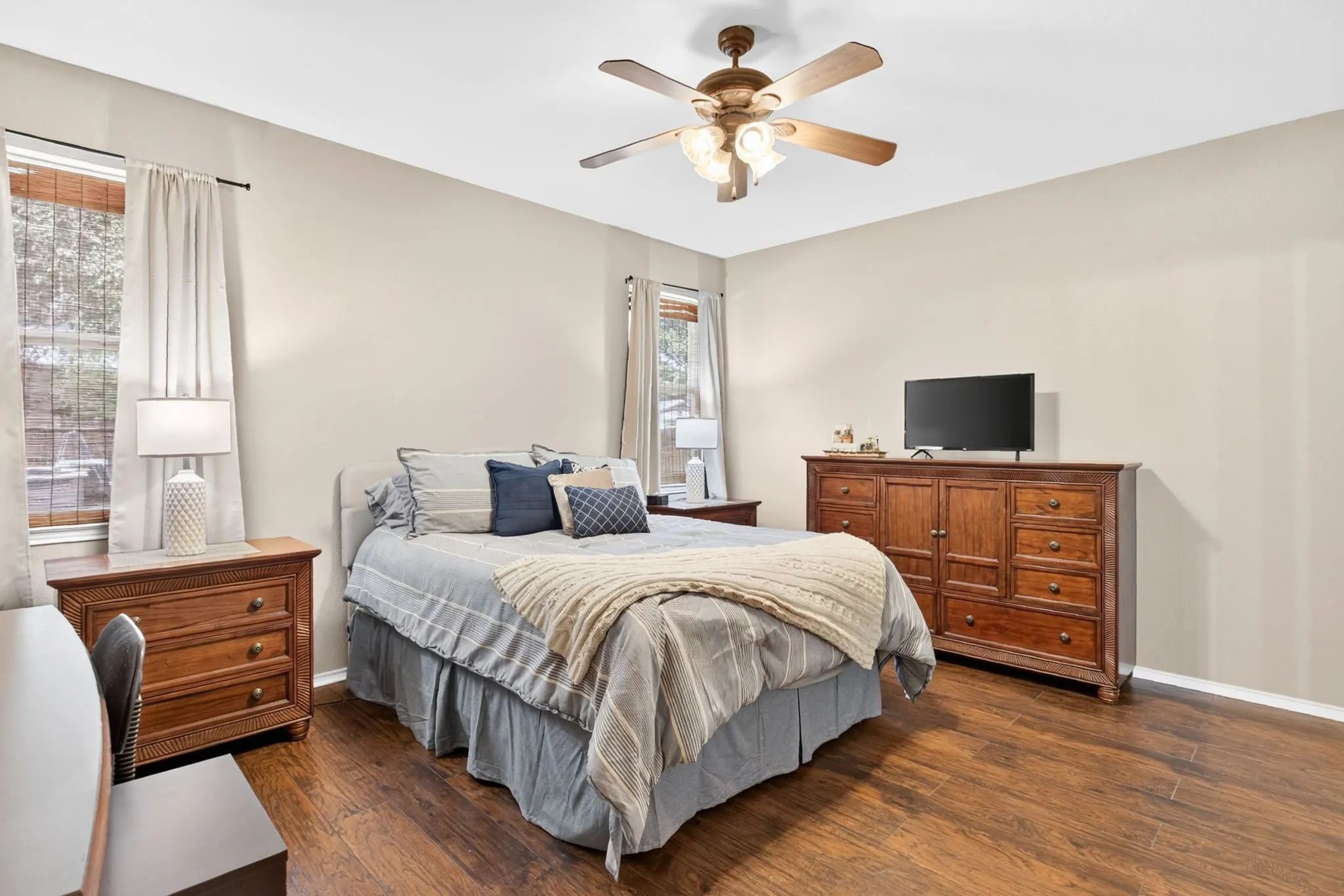 Wood-finish flooring, neutral wall tones, and multiple windows