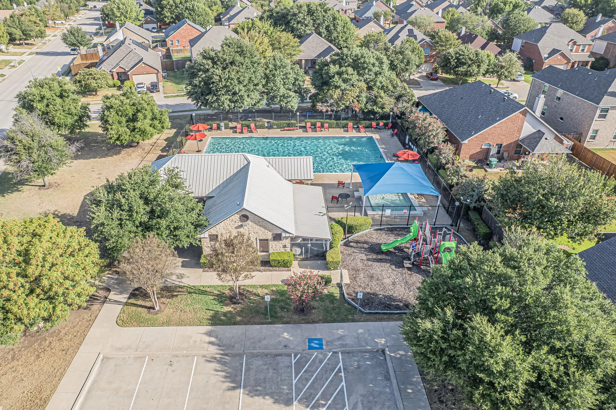 Community amenities include a swimming pool, shaded playground, stone-clad clubhouse, and dedicated parking
