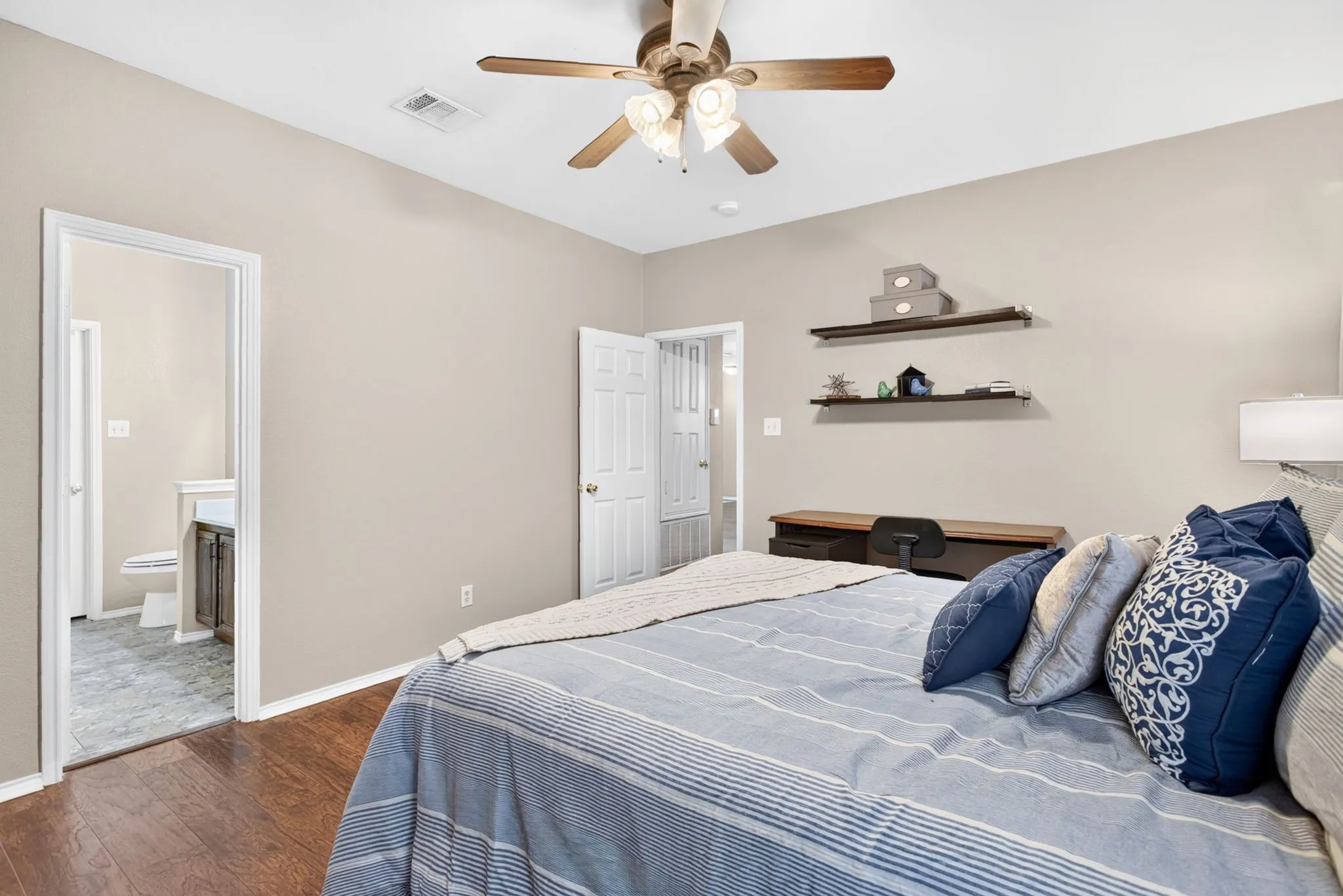 Wood-finish flooring throughout the room with light neutral wall paint