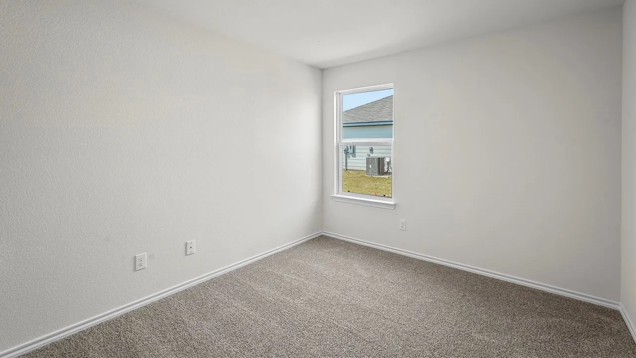 Wall-to-wall carpeting in a neutral tone, textured white walls, a white-framed window, and white trim