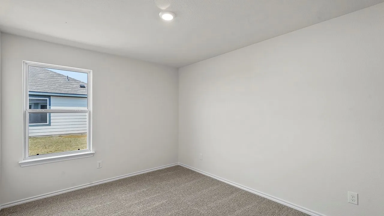 Recessed ceiling lighting, neutral-toned walls, double-hung window, and carpet flooring