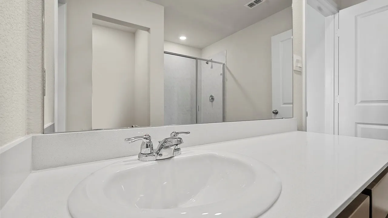White countertop with an integrated sink and chrome faucet