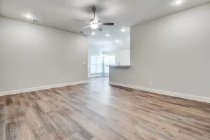 Wood-finish flooring throughout, recessed lighting, and a ceiling fan