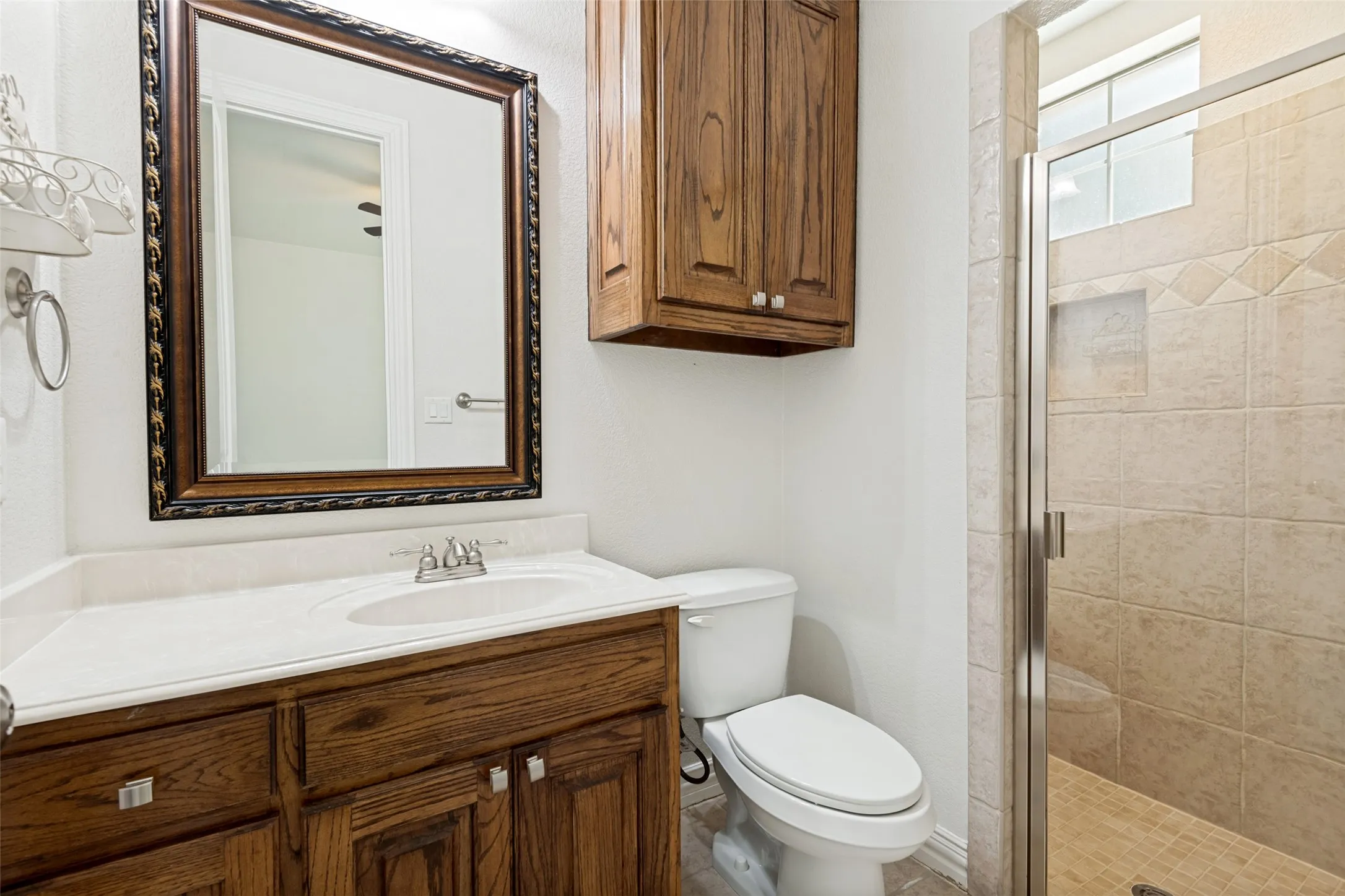 Wood-finish vanity with integrated sink and chrome fixtures